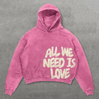 Women's pink hoodie with cream All We Need Is Love graphic