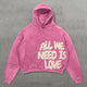 Women's pink hoodie with cream All We Need Is Love graphic