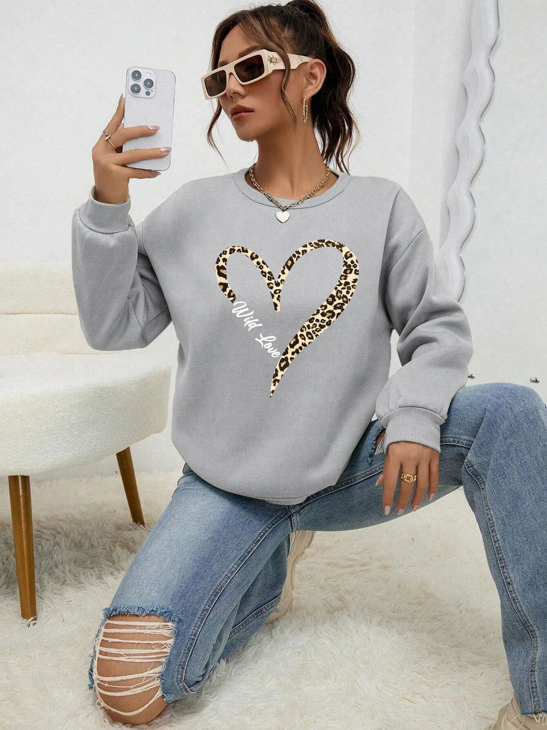 Women's crew-neck sweatshirt with leopard heart graphic and long sleeves