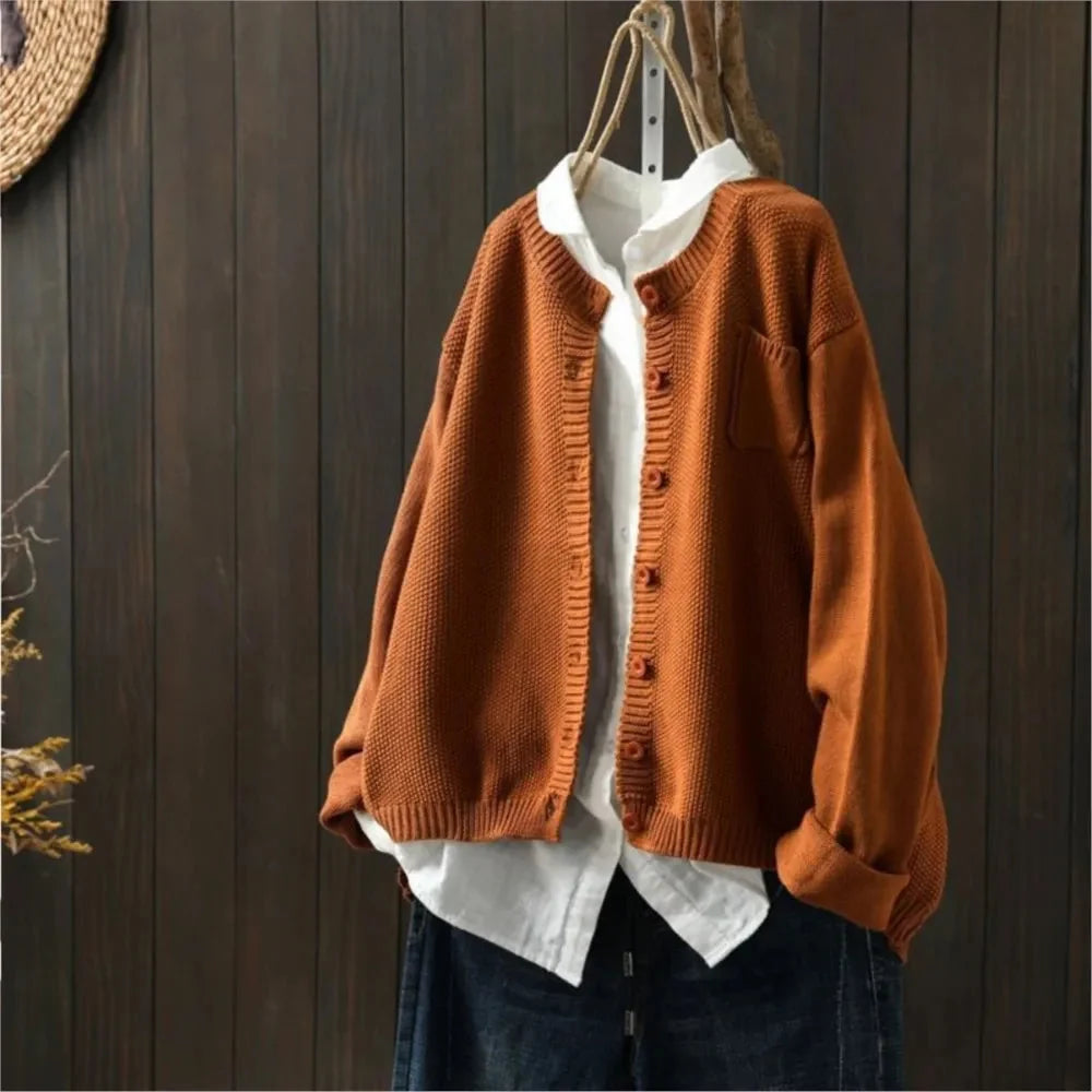 Women's textured knit cardigan with buttons over a white shirt