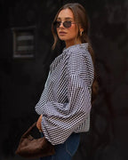 Women's checked shirt with open collar and long puff sleeves