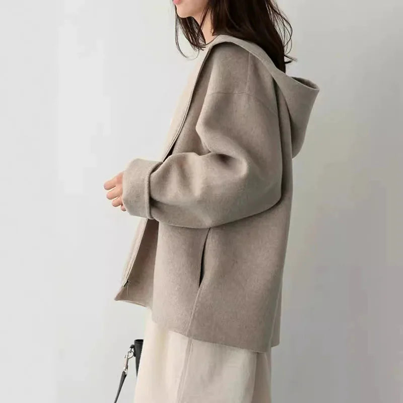 Women's hooded zip jacket with long sleeves and front pockets in beige and black