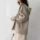 Women's hooded zip jacket with long sleeves and front pockets in beige and black