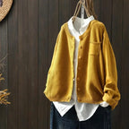 Women's textured knit cardigan with buttons over a white shirt