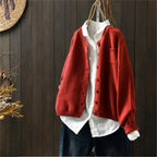 Women's textured knit cardigan with buttons over a white shirt