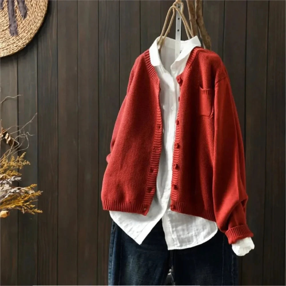 Women's textured knit cardigan with buttons over a white shirt