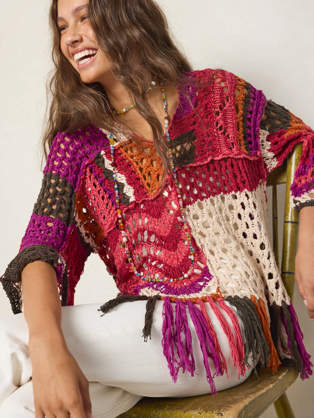 Women's multicolor crochet sweater with fringe hem and three quarter sleeves