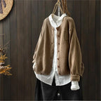 Women's textured knit cardigan with buttons over a white shirt