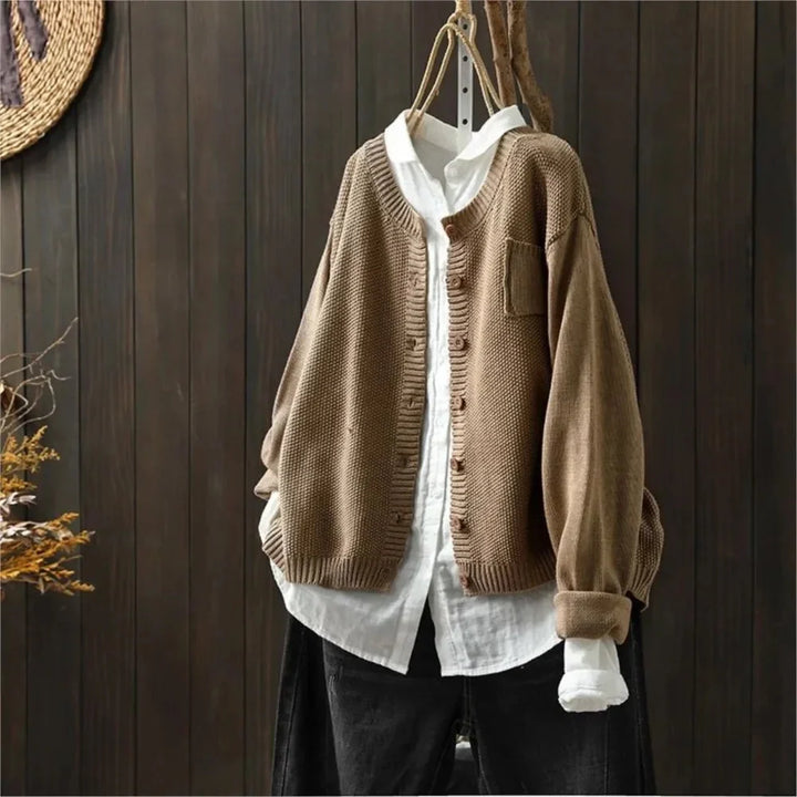 Women's textured knit cardigan with buttons over a white shirt