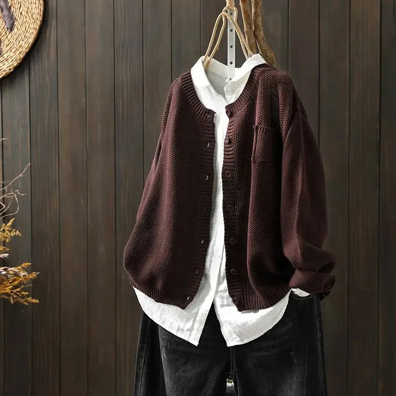 Women's textured knit cardigan with buttons over a white shirt