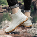 Black unisex ankle terrain boots with elastic side panels and chunky lug soles