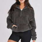 Women's textured hooded half-zip sweater with long sleeves and front pocket