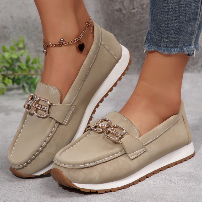 Women's slip-on loafers with moccasin stitching and decorative buckle detail