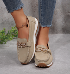 Women's slip-on loafers with moccasin stitching and decorative buckle detail