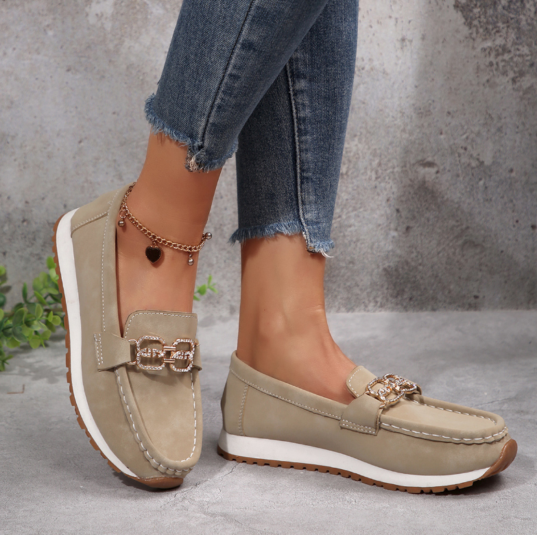 Women's slip-on loafers with moccasin stitching and decorative buckle detail