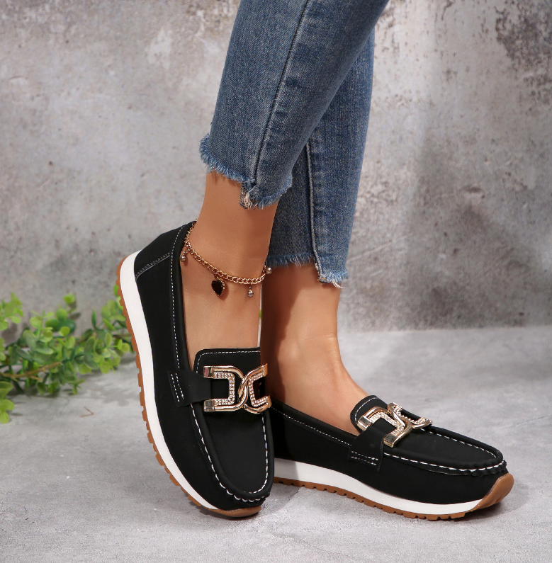 Women's slip-on loafers with moccasin stitching and decorative buckle detail