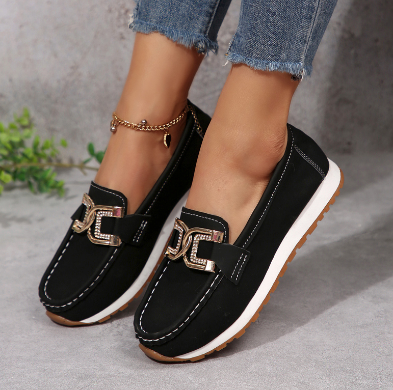 Women's slip-on loafers with moccasin stitching and decorative buckle detail