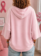 Women's hooded top with short sleeves, ghost graphic and pink ribbon sleeve details