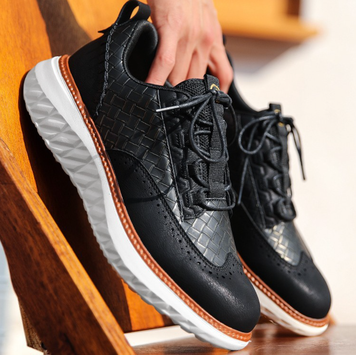Hand-stitched sneakers with textured panels and ridged soles