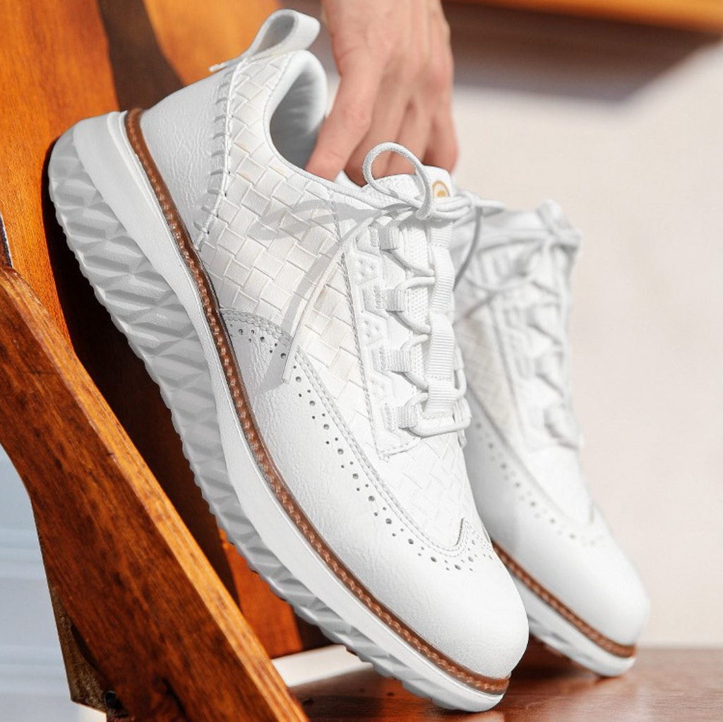 Hand-stitched sneakers with textured panels and ridged soles