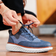 Hand-stitched sneakers with textured panels and ridged soles