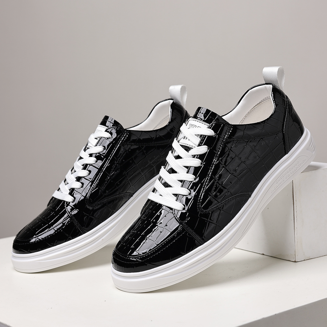 Glossy crocodile-effect trainers with white laces and platform soles