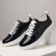 Glossy crocodile-effect trainers with white laces and platform soles