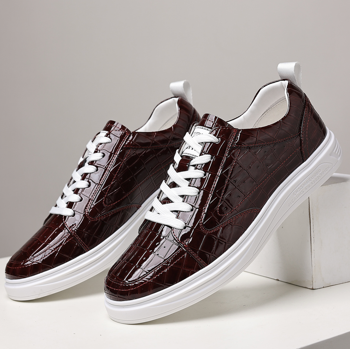 Glossy crocodile-effect trainers with white laces and platform soles