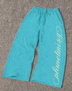Women's turquoise wide leg jogger trousers with side snaps and drawstring waist