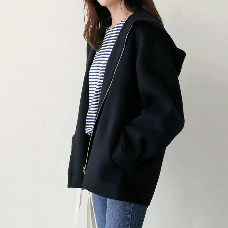Women's hooded zip jacket with long sleeves and front pockets in beige and black
