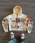Beige hooded zip hoodie with postal stamp graphics and long sleeves
