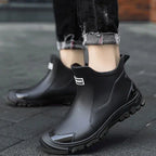Black unisex ankle terrain boots with elastic side panels and chunky lug soles