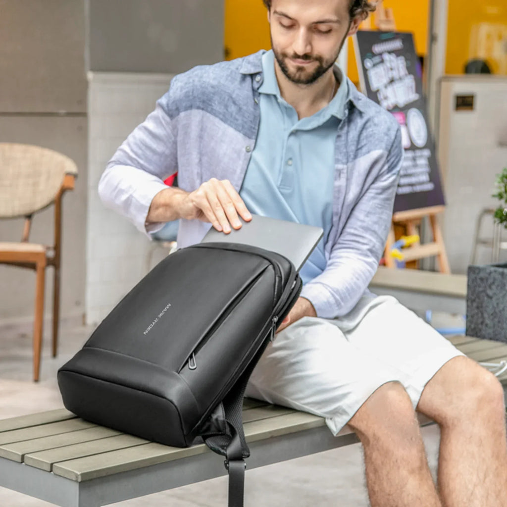 Black slim laptop backpack for men with padded straps and front pocket