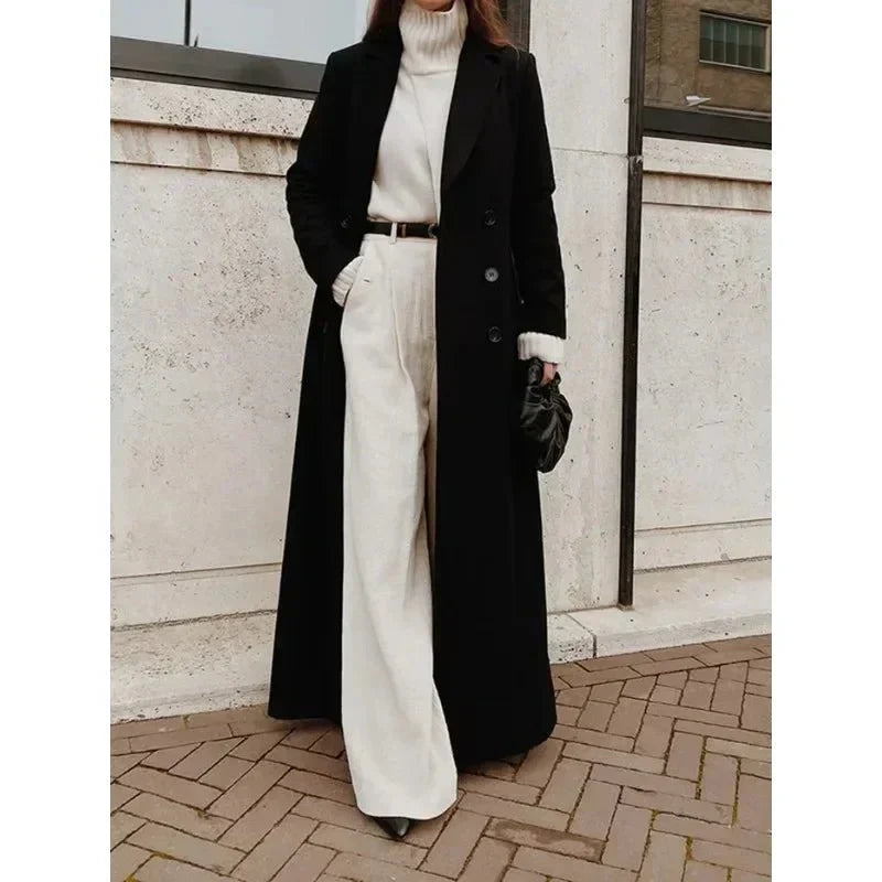 Women's long black maxi coat with notched lapels and button front