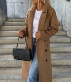 Women's long belted trench coat with notched lapels and double-breasted buttons