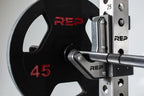 Black rubber coated Olympic weight plate marked 45 with three grip handles