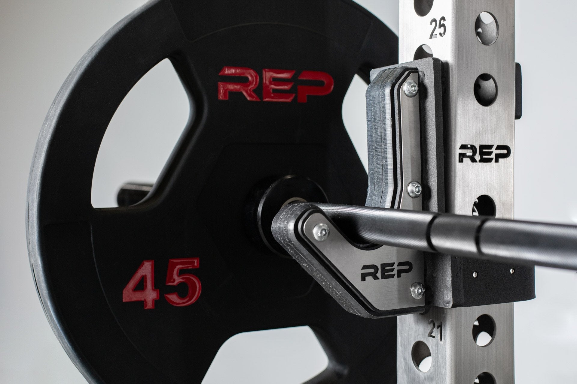 Black rubber coated Olympic weight plate marked 45 with three grip handles