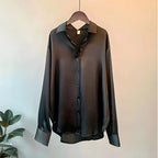 Women's long sleeve collared blouse with button front and curved hem