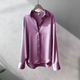 Women's long sleeve collared blouse with button front and curved hem