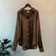 Women's long sleeve collared blouse with button front and curved hem
