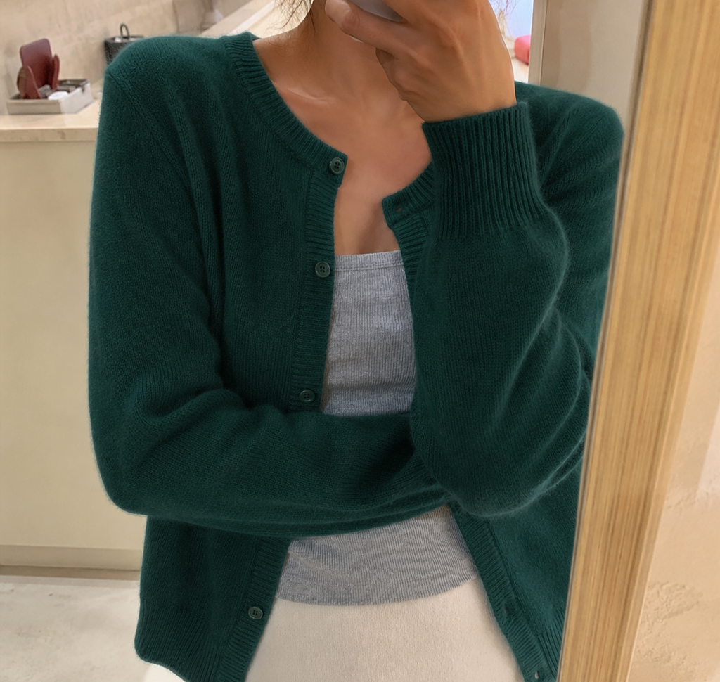 Women's waist-length knit cardigan with round neck and button front