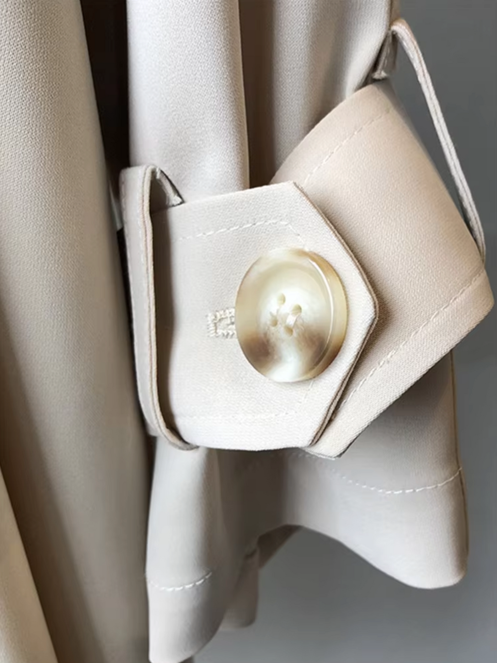 Women's long double breasted trench coat with lapel collar and cuff straps