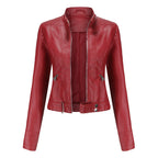 Women's fitted faux leather biker jacket with stand collar, long sleeves and zipped pockets