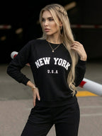 Women's black crew neck sweatshirt with white New York USA lettering