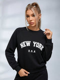 Women's black crew neck sweatshirt with white New York USA lettering