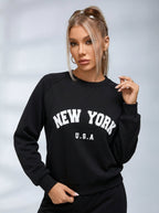 Women's black crew neck sweatshirt with white New York USA lettering