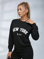Women's black crew neck sweatshirt with white New York USA lettering