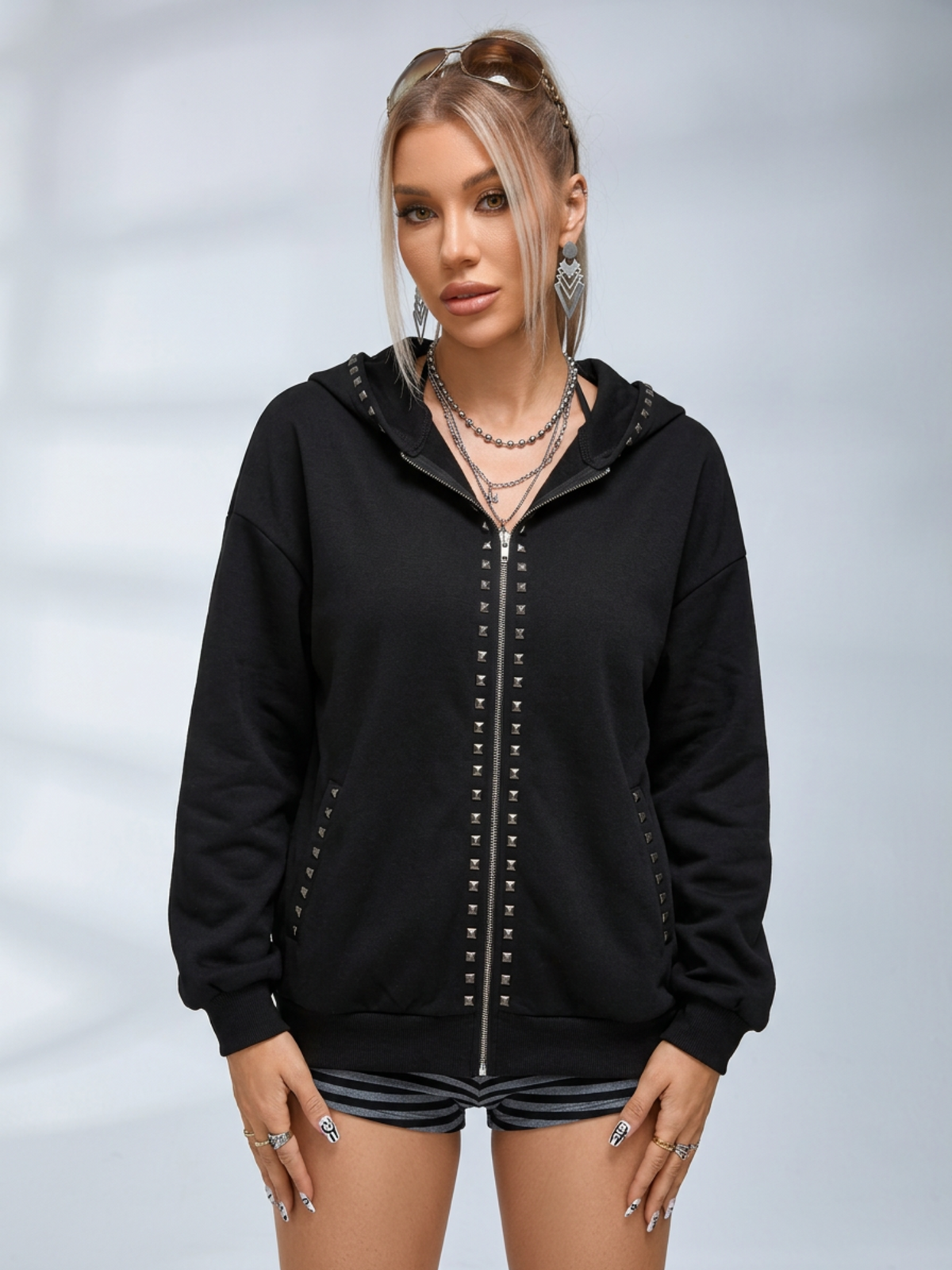 Black oversized hooded hoodie with full zip fastening, stud details and zipped pockets