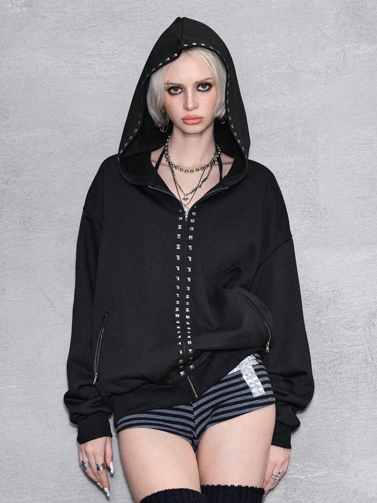 Black oversized hooded hoodie with full zip fastening, stud details and zipped pockets