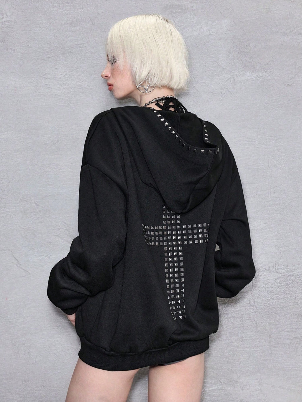 Black oversized hooded hoodie with full zip fastening, stud details and zipped pockets